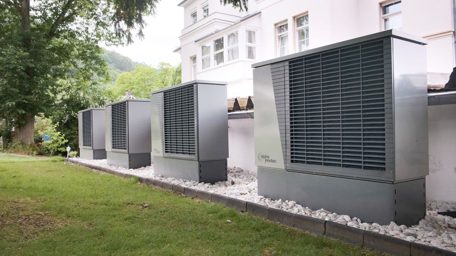 Row of outdoor heat pump units at a residence