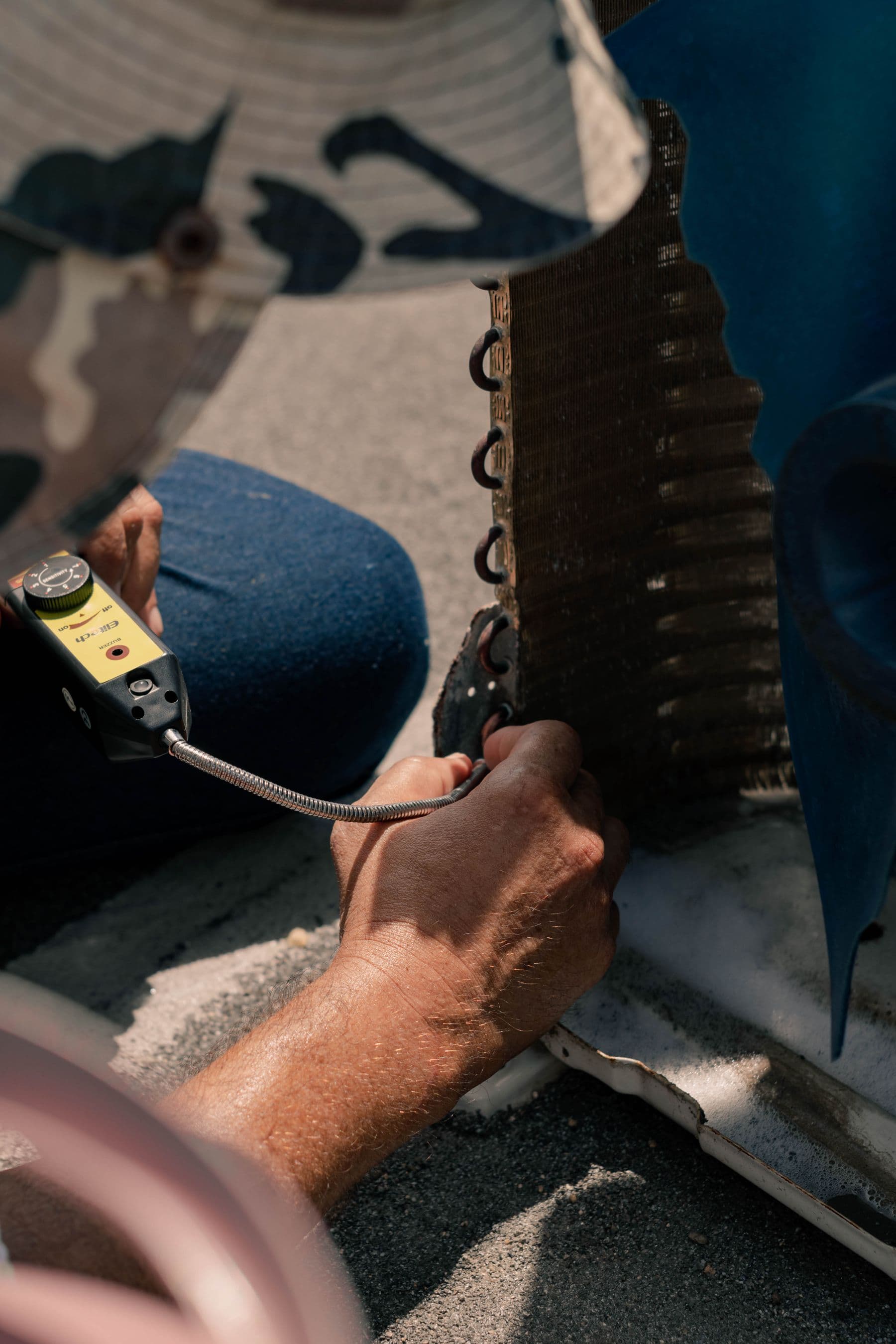 Technician servicing outdoor HVAC equipment